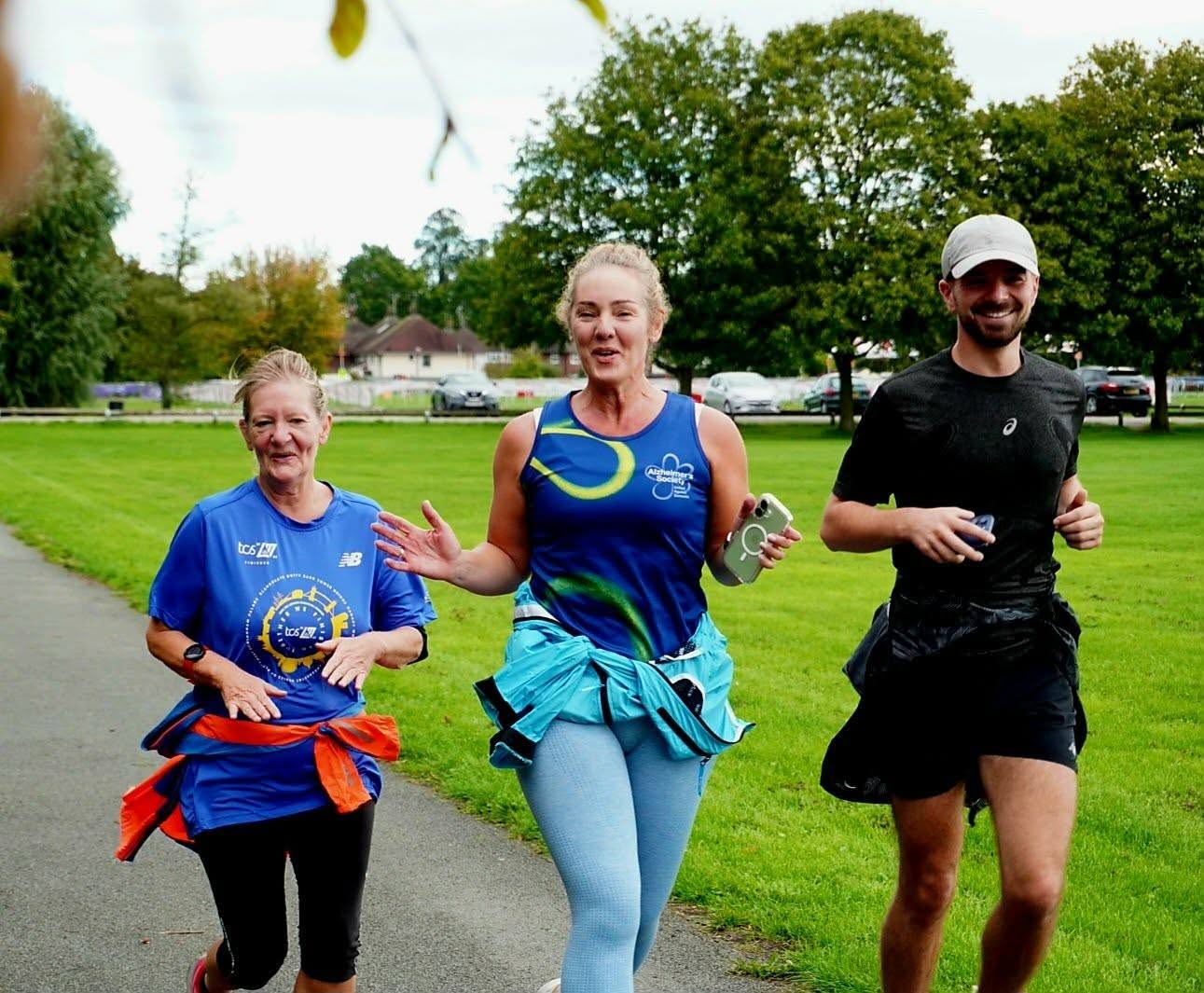 Three adults moving together at the continence awareness gathering