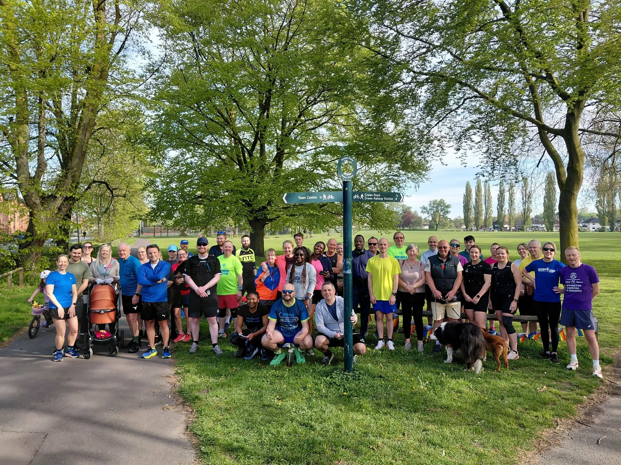 A large group of people gathering under the trees at Barony Park