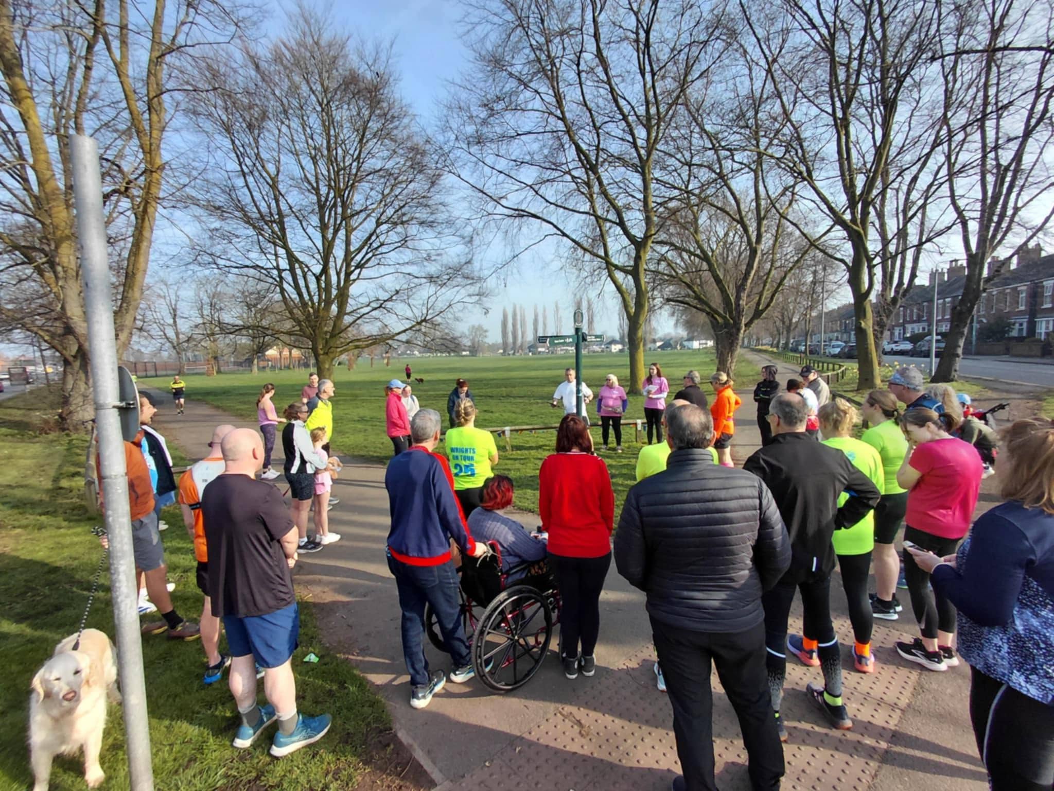 A group sets off along a park path at a neurodiversity themed Dash